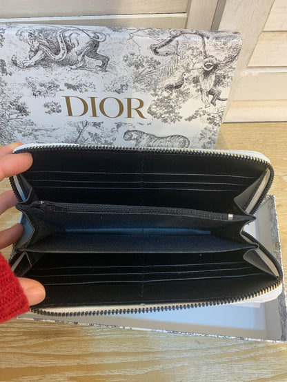 Two white Dior purses with a box