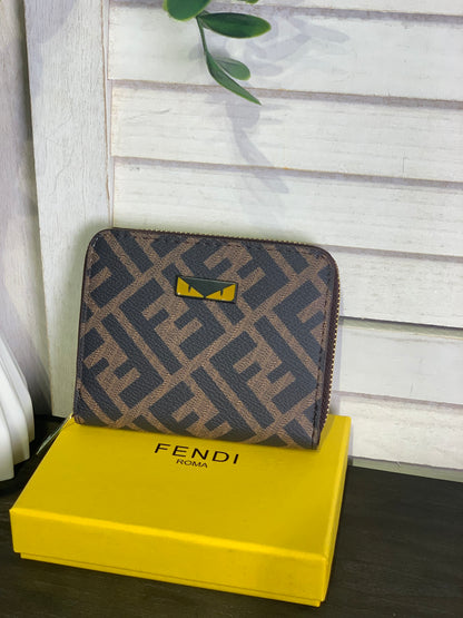 Two small Fendi purses with a box