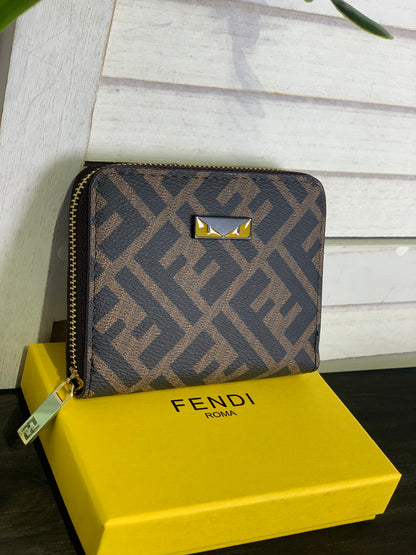 Two small Fendi purses with a box