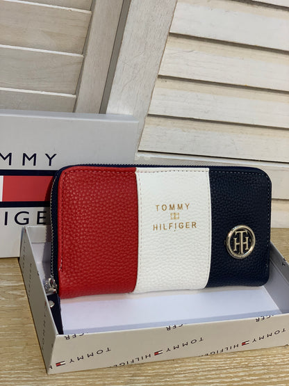 Two Tommy wallets with box