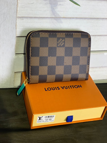 Two small Louis Vuitton purses with a box