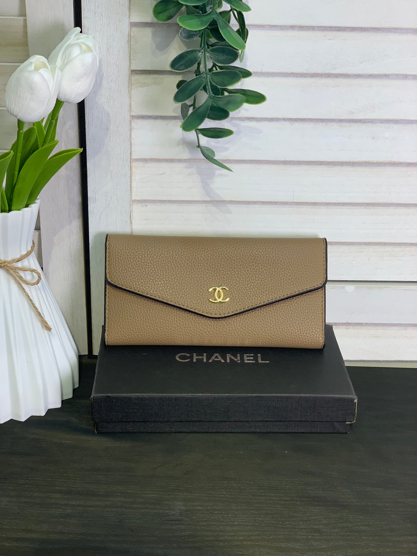 Two large beige Chanel purses with a box