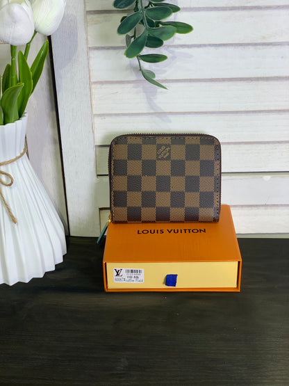 Two small Louis Vuitton purses with a box