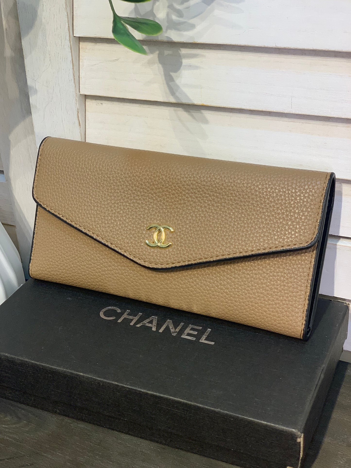 Two large beige Chanel purses with a box