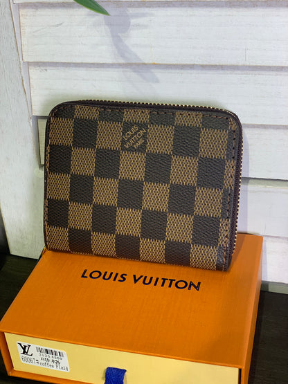 Two small Louis Vuitton purses with a box