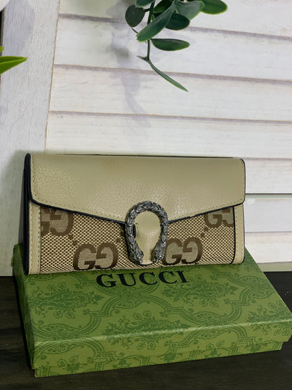 Two large Gucci purses with a box