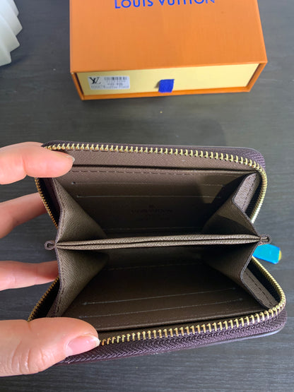 Two small Louis Vuitton purses with a box