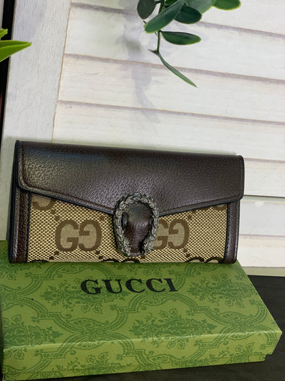 Two large Gucci purses with a box