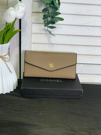 Two large beige Chanel purses with a box