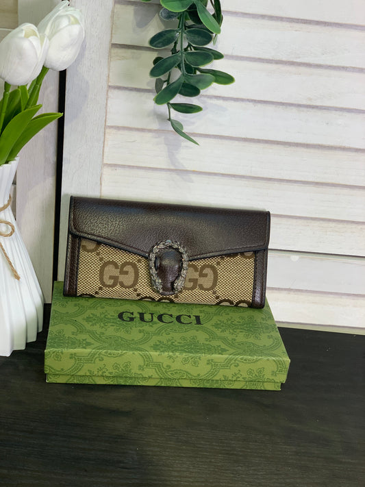 Two large Gucci purses with a box